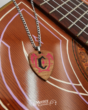 Photo du collier médiator initiale C. Le médiator est en bois d'Orme, le C en lettrage gothique noir et les motifs pinstriping qui l'entourent en rouge.